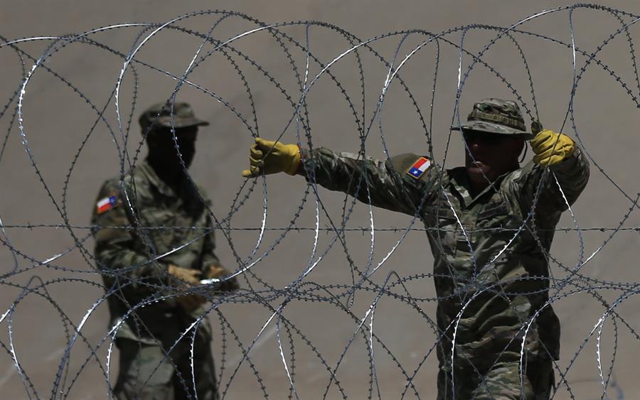 Fotografía de archivo, tomada el pasado 30 de julio, en la que se registró a miembros de la Guardia Nacional de Texas al reforzar la frontera con alambre de púas aceradas, debajo del Puente Internacional Reforma, frente a Ciudad Juárez (Chihuahua, México). EFE/Luis Torres