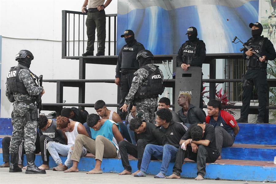 Policías custodian hoy a los detenidos de un grupo armado por la toma temporal de un canal de televisión ayer, en Guayaquil (Ecuador). EFE/Carlos Durán Araújo