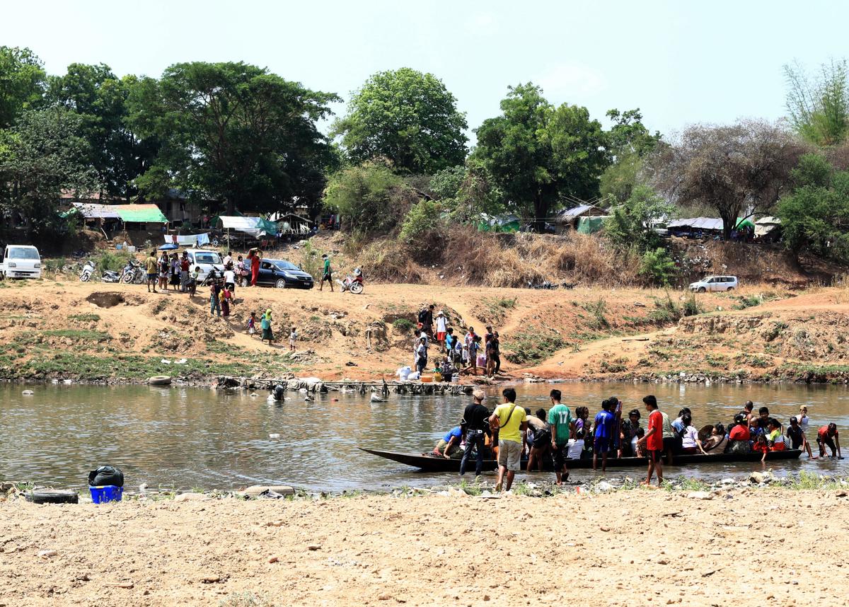 BIrmanos cruzan el río Moei en la frontera entre Birmania y Tailandia para huir de los enfrentamientos entre las fuerzas pro y anti junta militar.EFE/EPA/SOMRERK KOSOLWITTHAYANANT