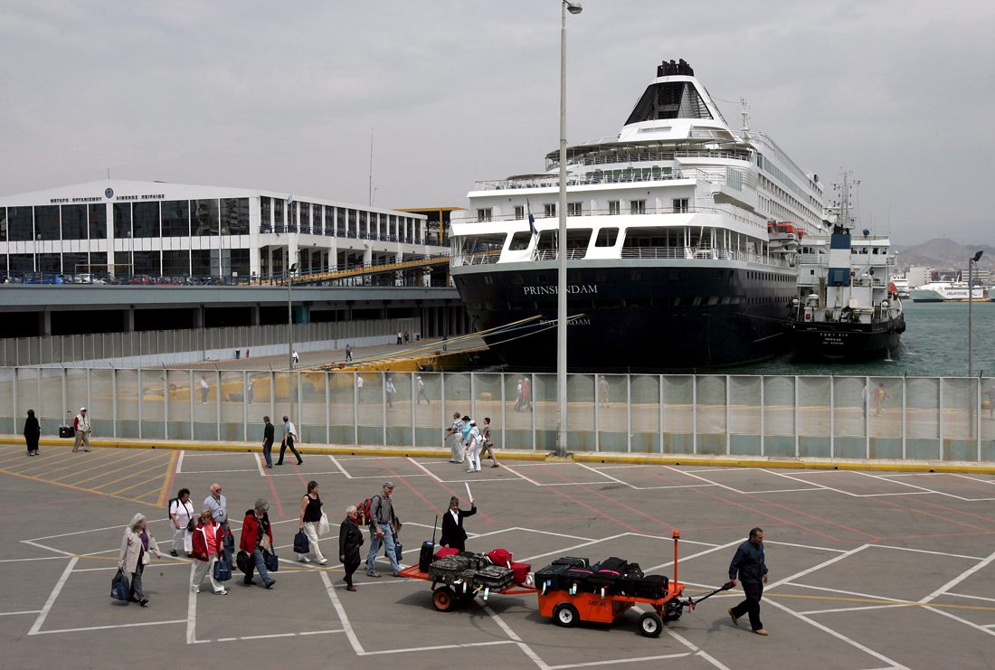 En la imagen de archivo, los pasajeros de un crucero transportan su equipaje en el puerto de Piraeus, Grecia. EFE/ORESTIS PANAGIOTOU