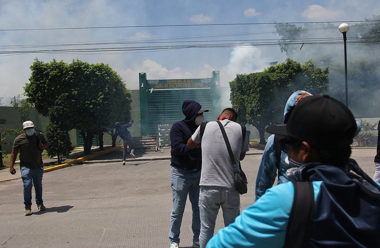 Manifestantes protestan al exterior de una de las entradas del Batallón 27 de Infantería este viernes, en el municipio de Iguala, en el estado de Guerrero (México). (Foto de José Luis de la Cruz de la agencia EFE)