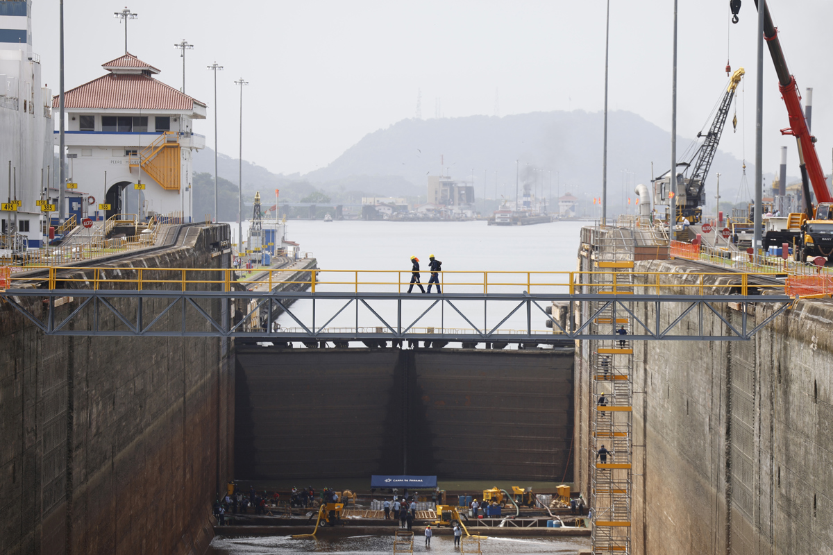 Personas trabajan en labores de reacondicionamiento y mantenimiento preventivo en cámara seca este viernes, en las esclusas de Pedro Miguel del Canal de Panamá (Panamá). (Foto de Bienvenido Velasco de la agencia EFE)
