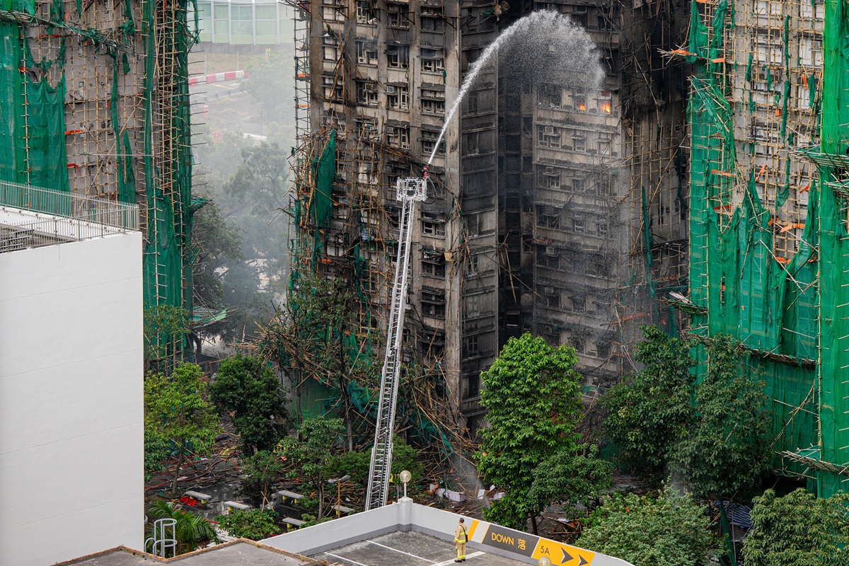 Bomberos echan agua a un departamento en llamas en Tai Po, distrito de Hong Kong, China, 27 November 2025. (Foto de Leung Man Hei de la agencia EFE/EPA)